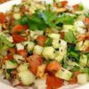 Fresh salad with avocado, papaya, lettuce, sweet pepper, cucumber, rice vinegar